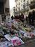 Flowers, candles, notes and other offerings pour into the streets from the doorstep of the offices of Charlie Hebdo where 12 workers were killed by terrorists Wednesday.
