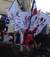 A little girl holds the French flag high alongside the International League Against Racism and Anti-Semitism.